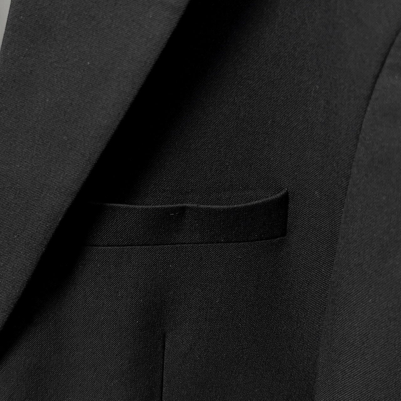 Suit with buttons at waist