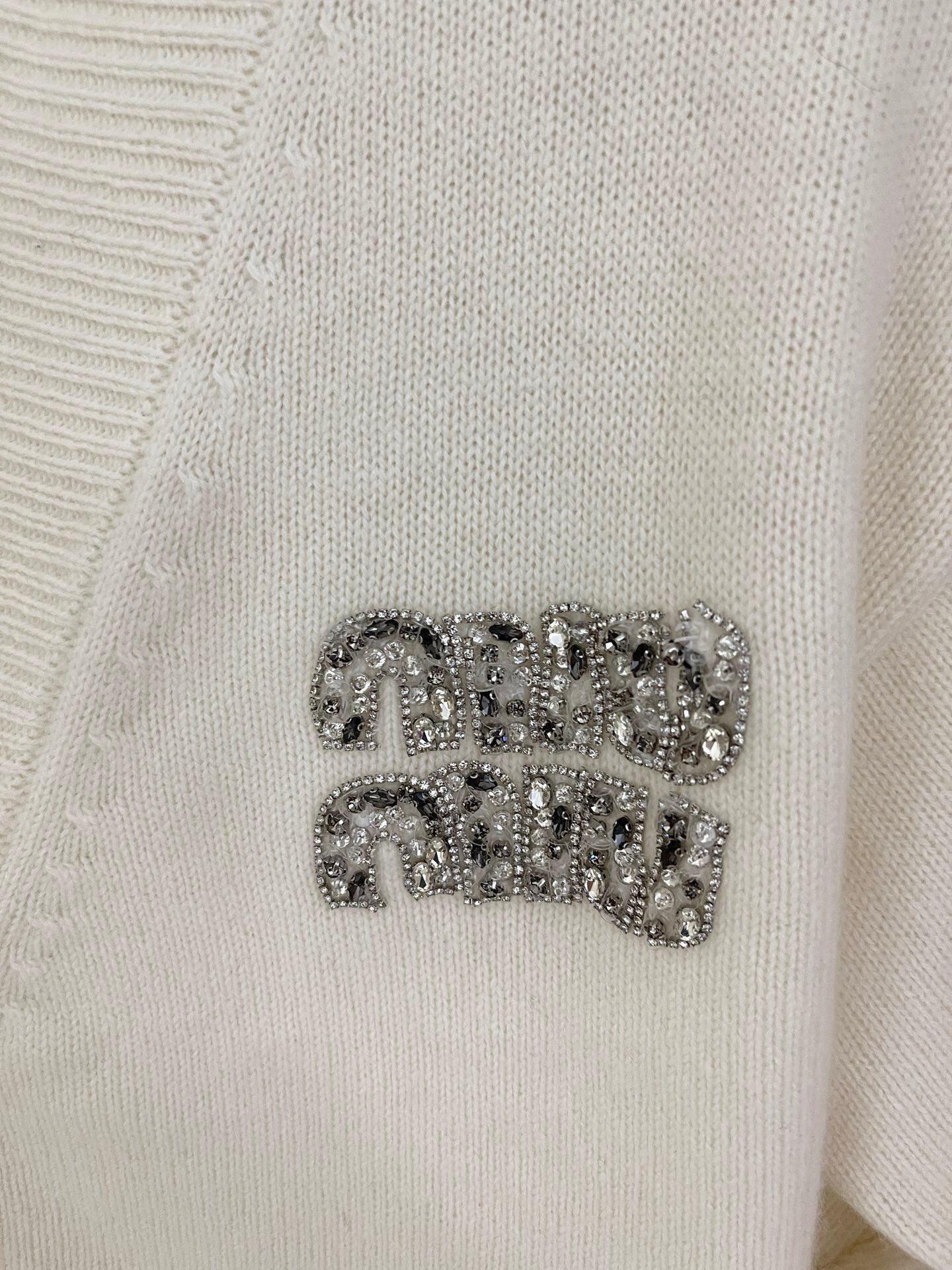 Knitted cardigan with rhinestone logo